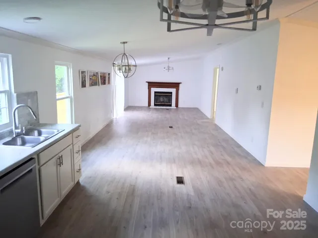 a view of a kitchen and a sink wooden floor