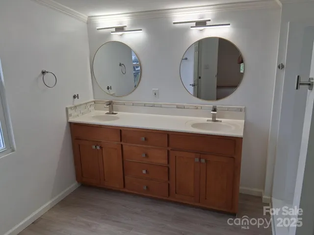 a bathroom with double vanity sinks and a mirror