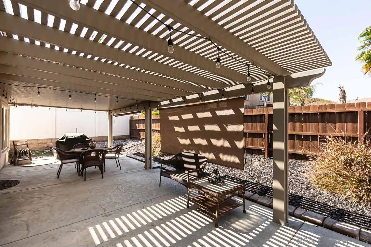 8538 Paseo De Los Castillos Santee, CA 92071 - Photo 19 of 20 a view of a patio with table and chairs with wooden floor and fence