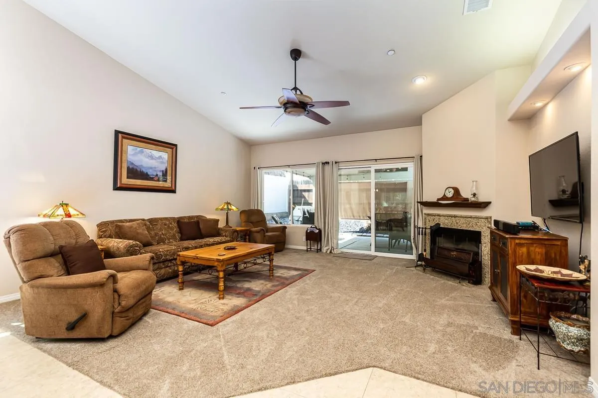 8538 Paseo De Los Castillos Santee, CA 92071 - Photo 5 of 20 a living room with furniture a ceiling fan and a flat screen tv