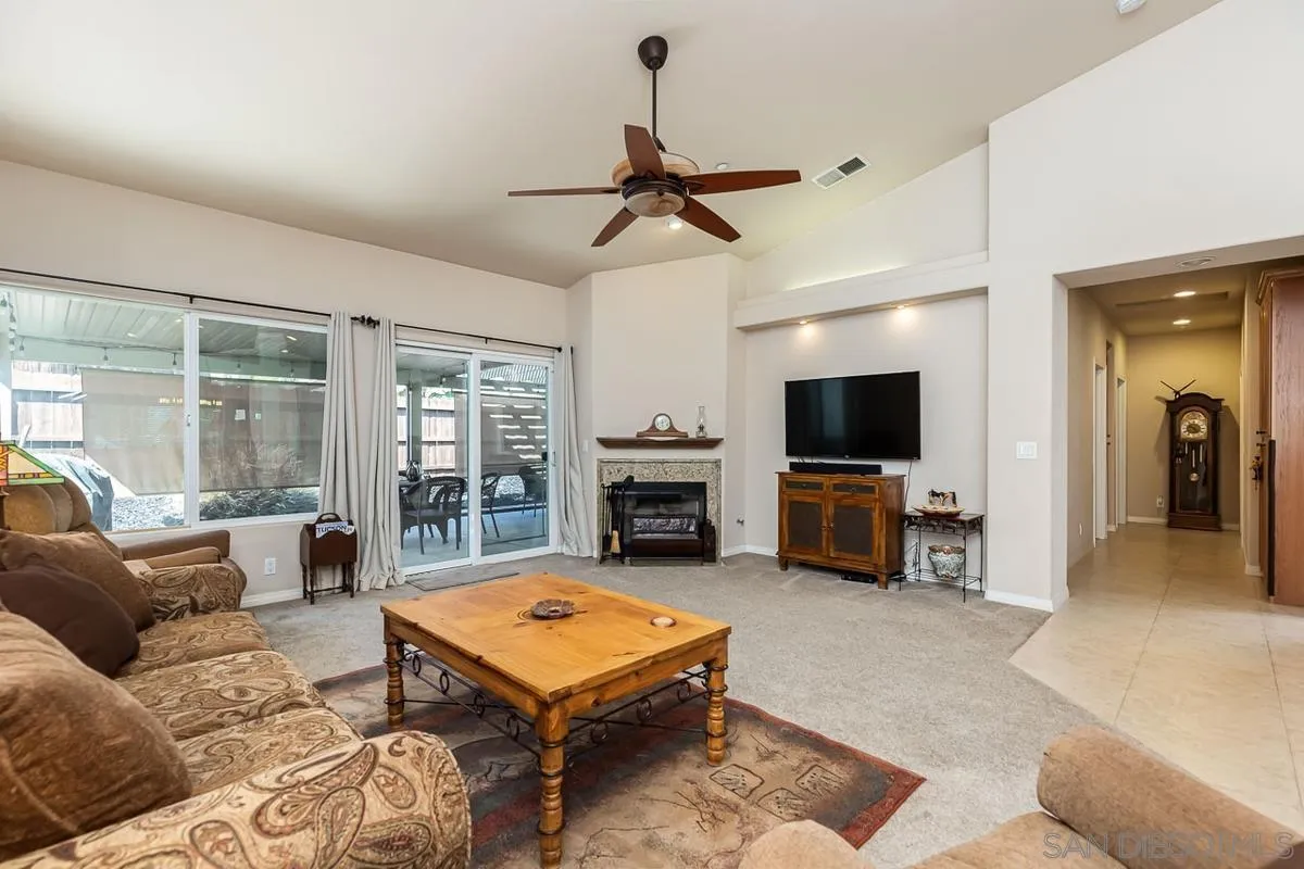 8538 Paseo De Los Castillos Santee, CA 92071 - Photo 6 of 20 a living room with furniture flat screen tv and a fireplace