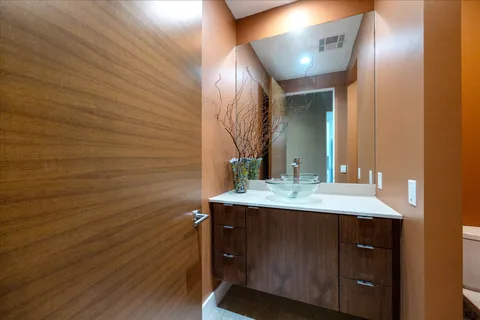 a bedroom with a bed and a flat tv screen on dresser
