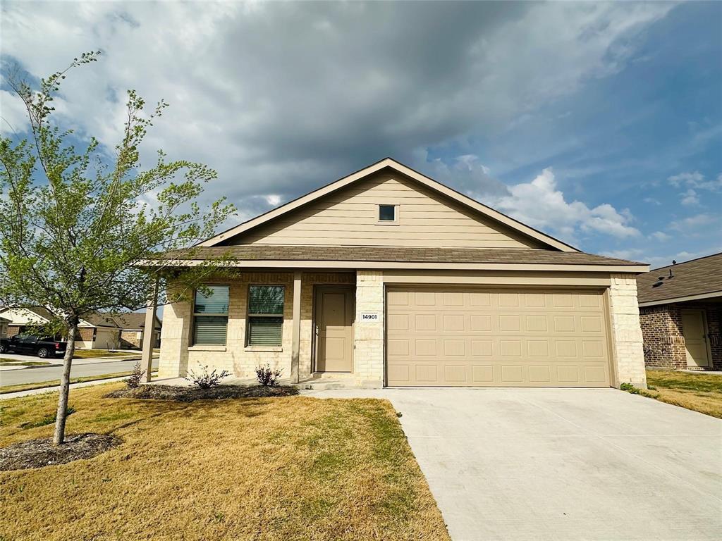 a front view of a house with a yard and garage