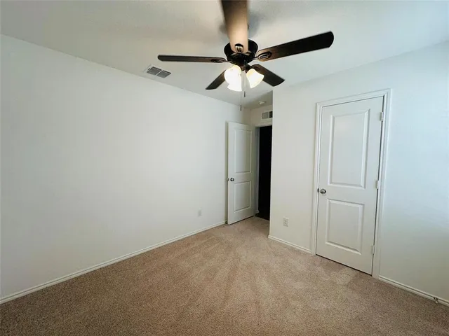 a view of room with a ceiling fan
