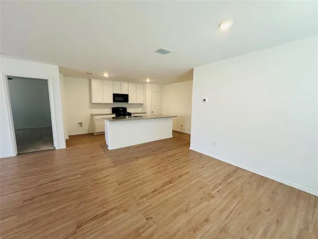 a view of kitchen with wooden floor