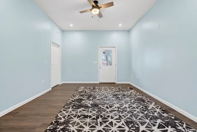 wooden floor in an empty room with a rug