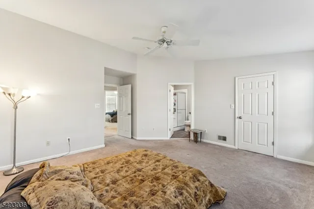 a bedroom with a bed and a mirror