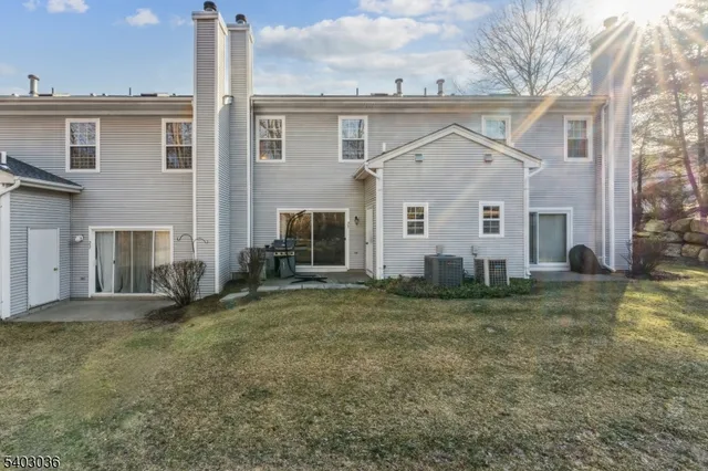 a view of a house with patio and backyard