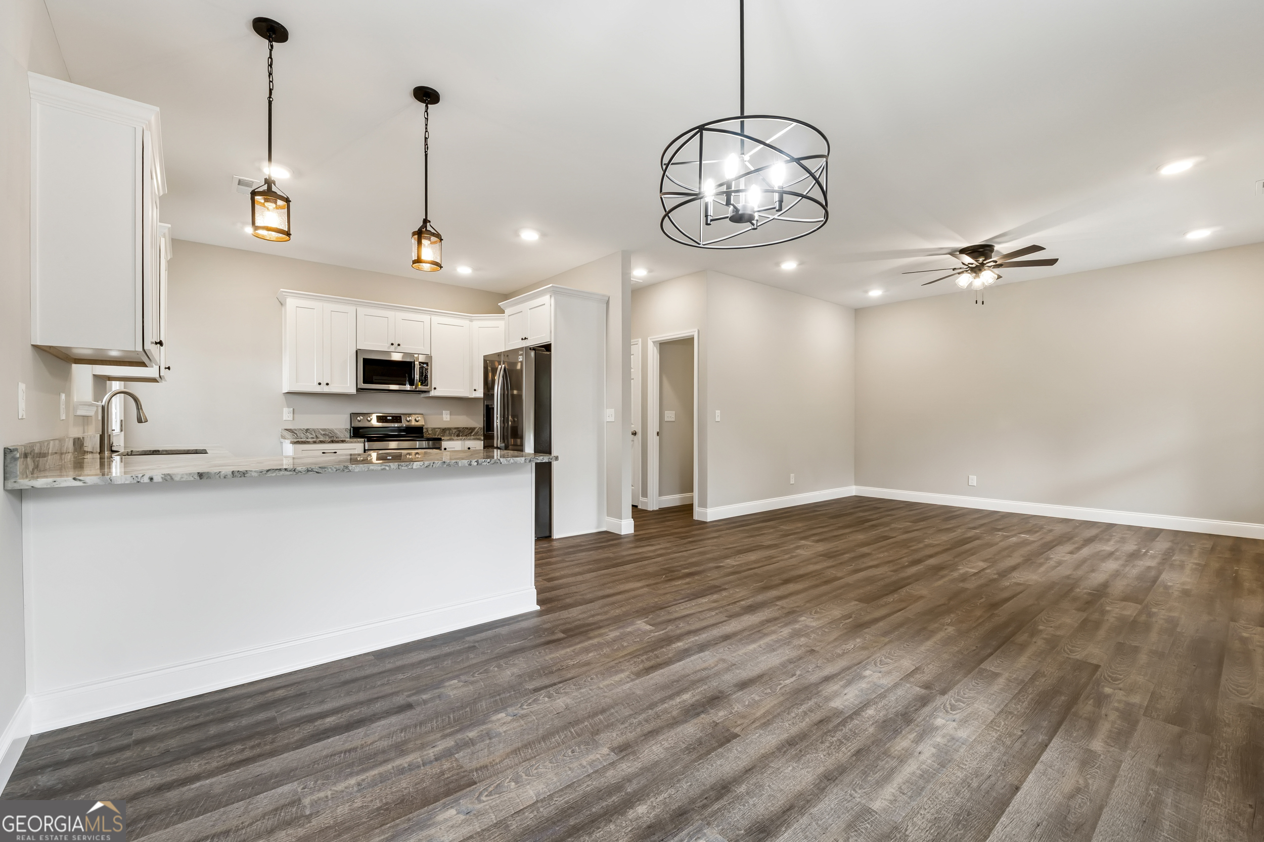 111 Hosea Street Rome, GA 30161 - Photo 6 of 14 a view of a kitchen with a sink wooden floor and cabinets