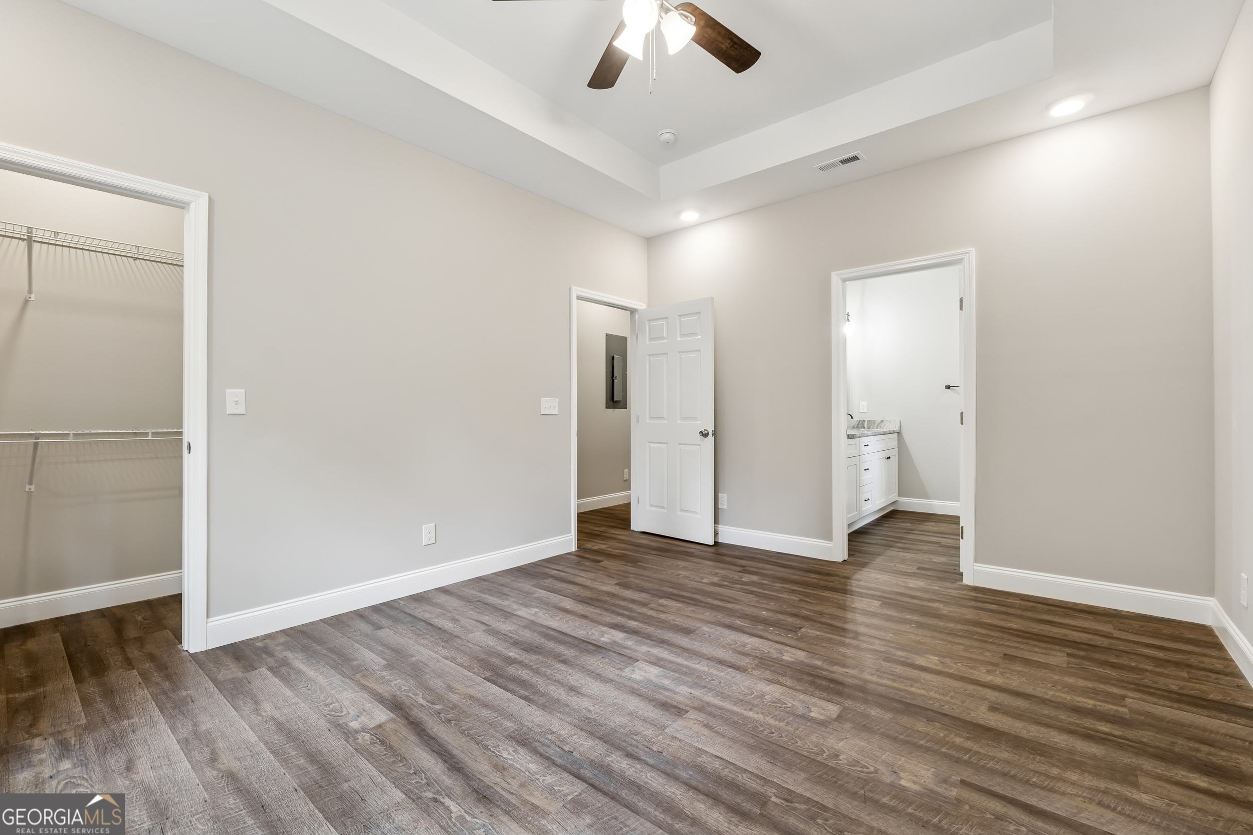 111 Hosea Street Rome, GA 30161 - Photo 9 of 14 an empty room with wooden floor ceiling fan and windows