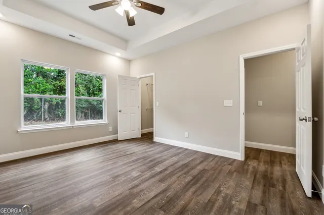 a view of wooden floor and windows in a room