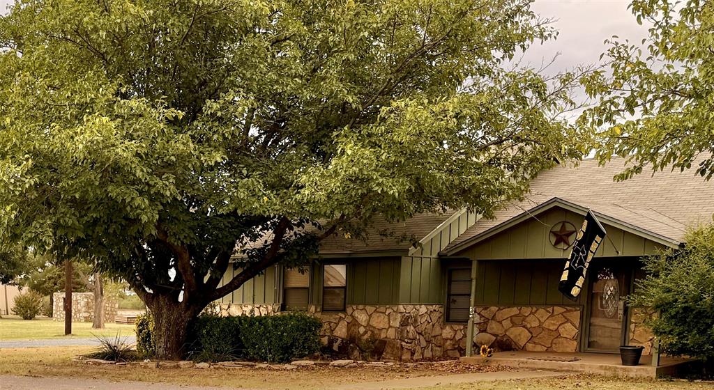 504 Loop Road Quanah, TX 79252 - Photo 2 of 40 View of front of home with stone siding and a shingled roof
