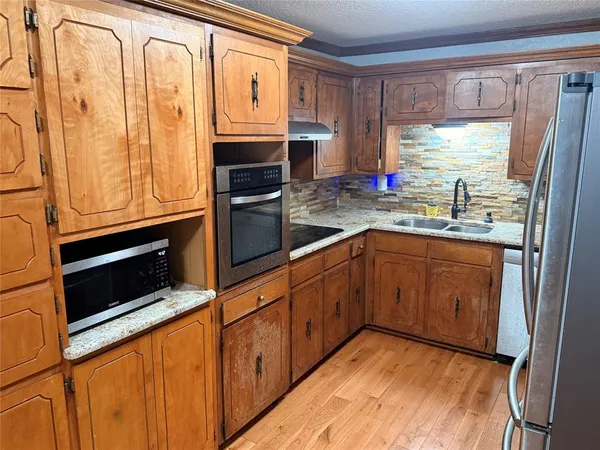 a kitchen with refrigerator and window