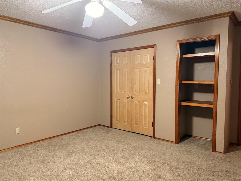 504 Loop Road Quanah, TX 79252 - Photo 36 of 40 Closet door and built in shelves