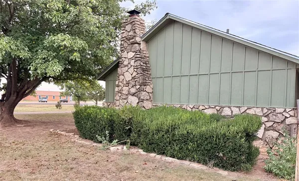 a front view of a house with trees