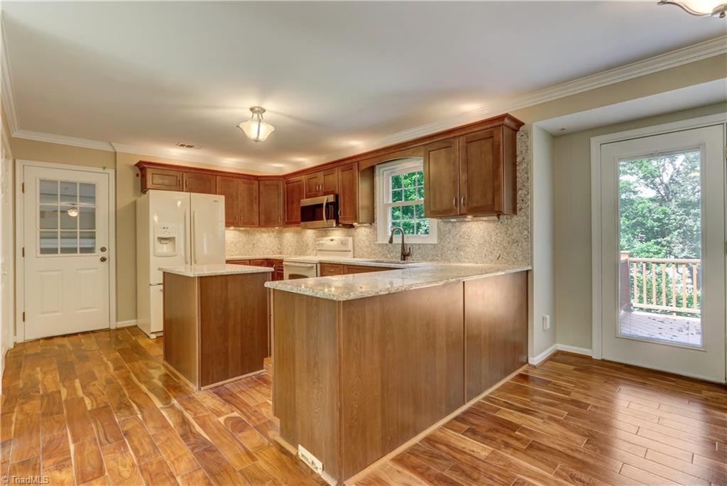 3603 Chance Road Greensboro, NC 27410 - Photo 11 of 30 Kitchen with Granite Countertops and Backsplash--Plus Island