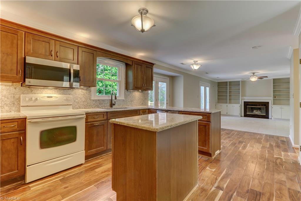 3603 Chance Road Greensboro, NC 27410 - Photo 13 of 30 Of course, as you can see, the greatroom with fireplace, tile flooring and built-ins are directly open to the kitchen.