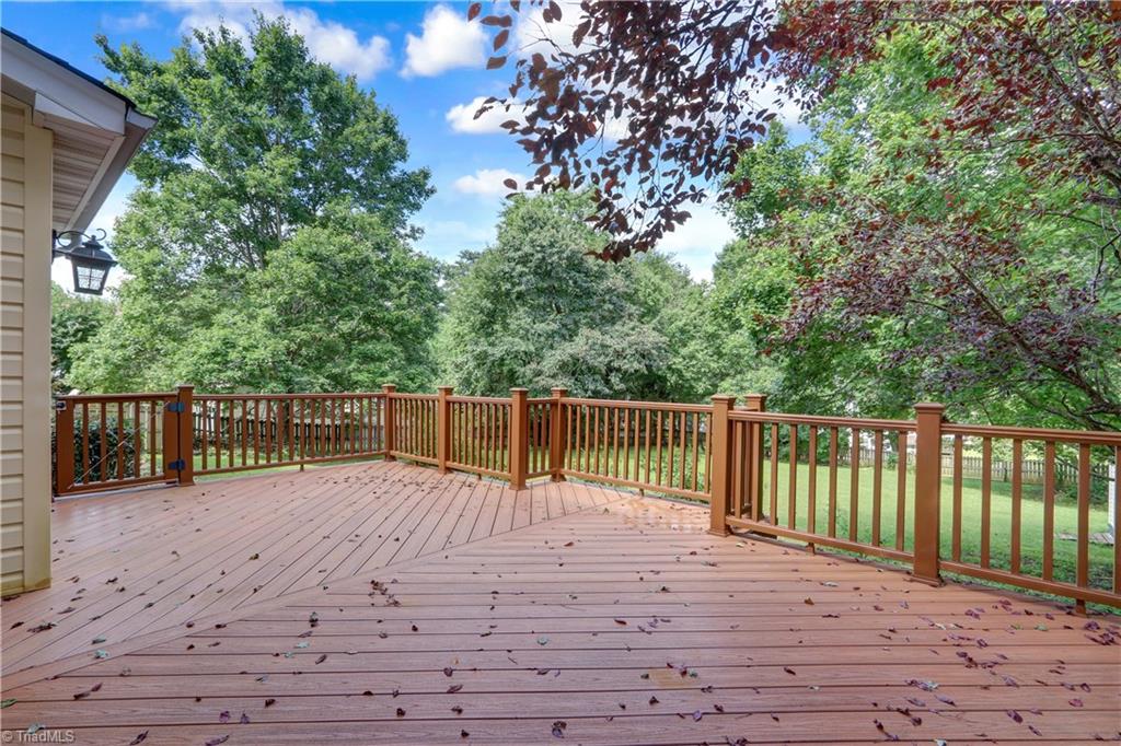 3603 Chance Road Greensboro, NC 27410 - Photo 26 of 30 An expansive and easily maintained Trex Deck overlooks the huge fenced back yard.