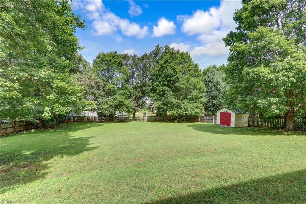 3603 Chance Road Greensboro, NC 27410 - Photo 27 of 30 A back yard with room for the kids and pets to play, or a place for a garden. Of course, you will need the storage bullding shown for playthings and yard tools.