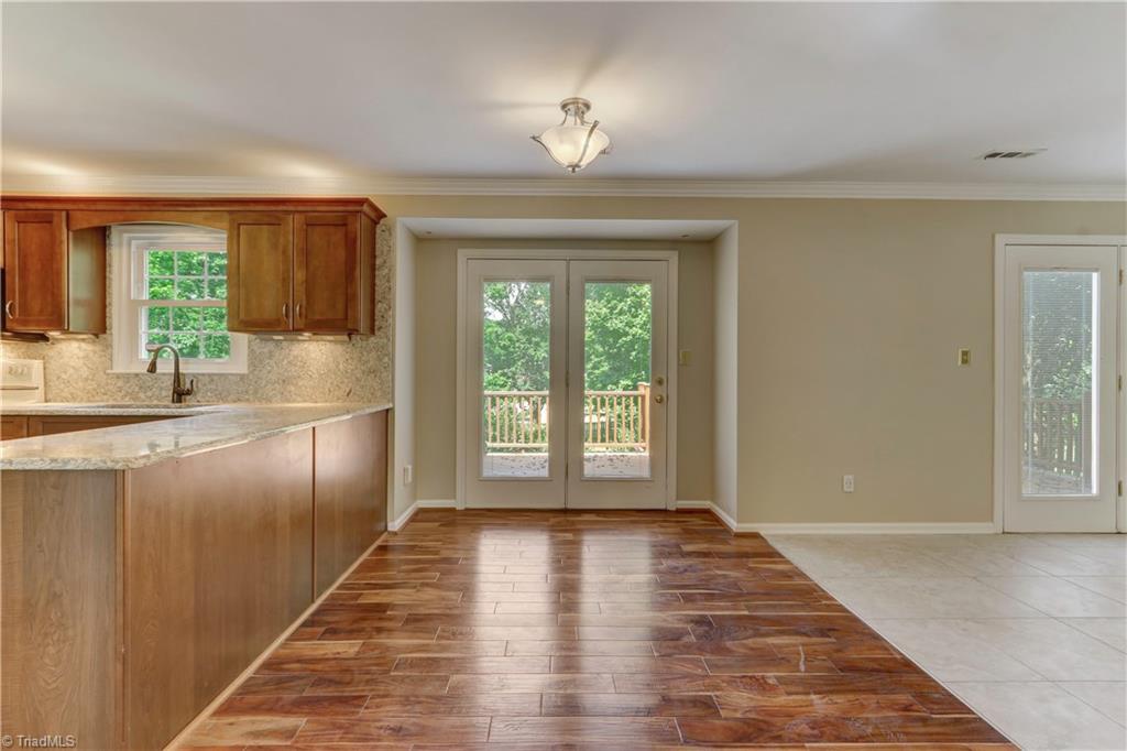 3603 Chance Road Greensboro, NC 27410 - Photo 10 of 30 Lighting abounds through the glass doors that lead out to the Trex deck and huge backyard.