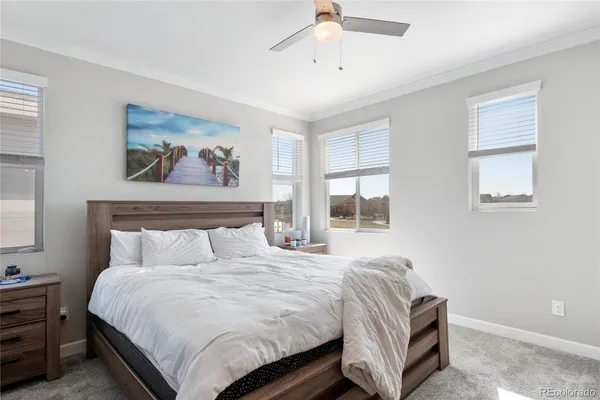 a bedroom with a bed and a painting on the wall