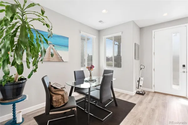 a view of a dining room with furniture window and wooden floor