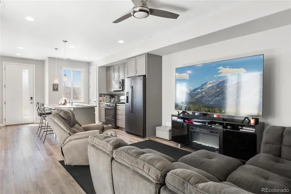 a living room with furniture and kitchen view