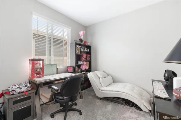 a living room with furniture and a chair