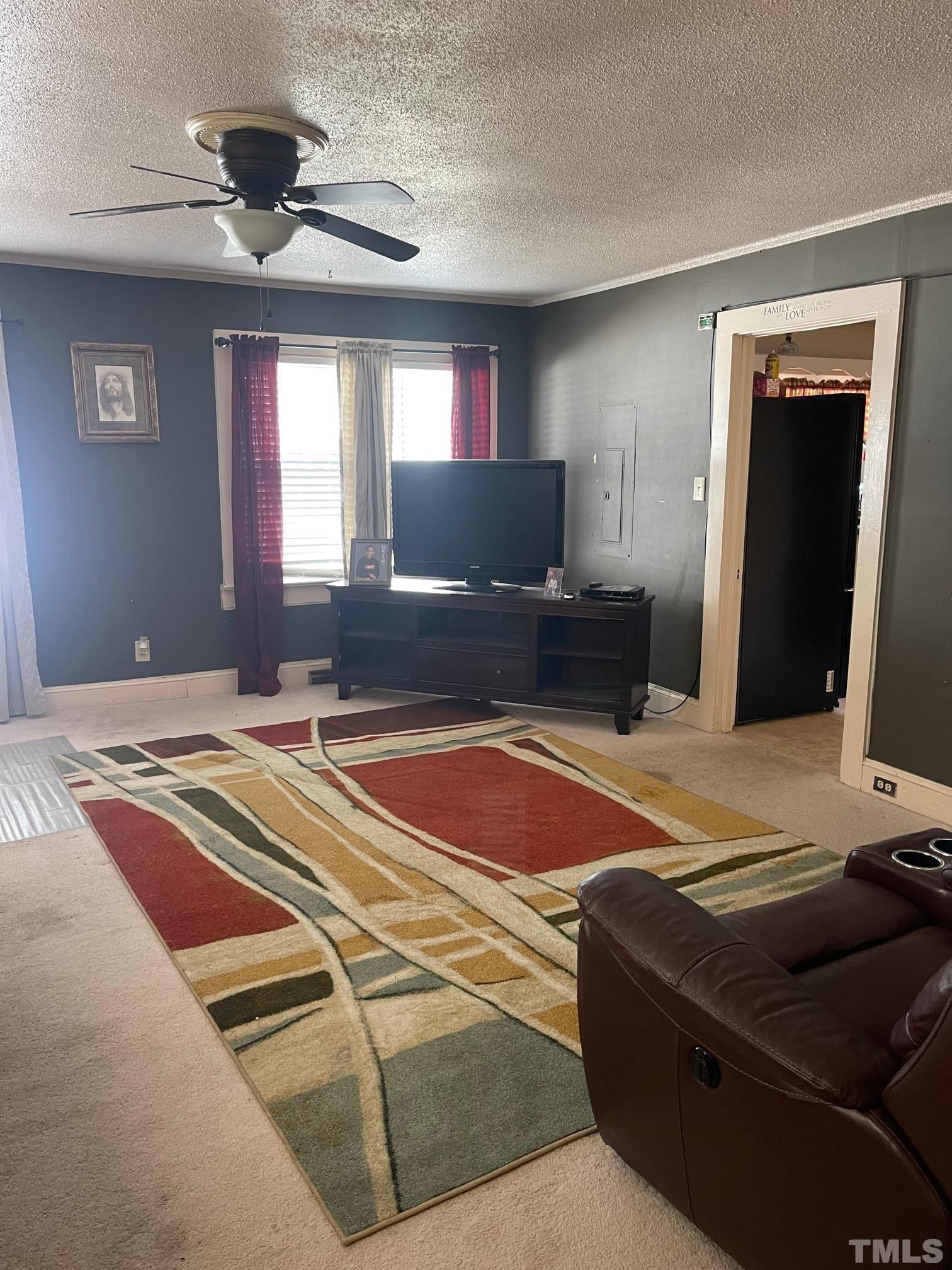 55 Jonesboro Road Dunn, NC 28334 - Photo 3 of 24 a bedroom with a bed and a chandelier