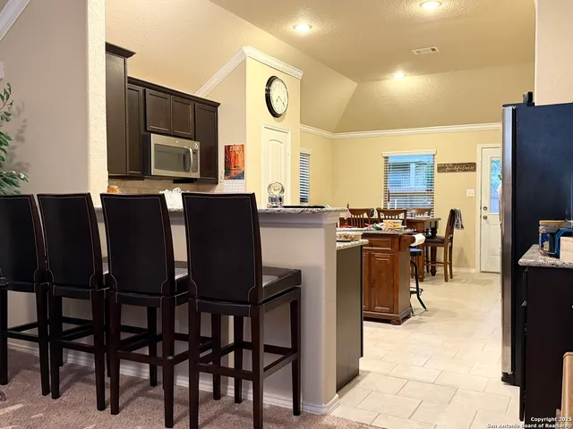 a view of kitchen with dining room and stainless steel appliances