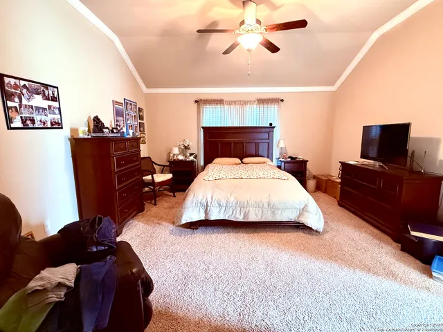 a bedroom with a bed window and a flat screen tv