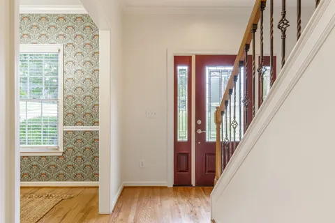 a dining room with furniture and wooden floor