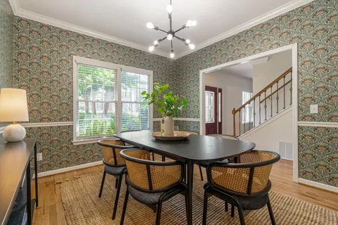a view of a kitchen and dining room with wooden floor