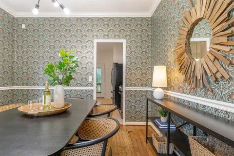 a view of a refrigerator in kitchen and wooden floor
