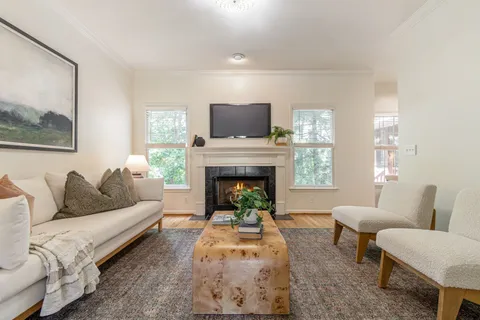 a living room with furniture and a fireplace