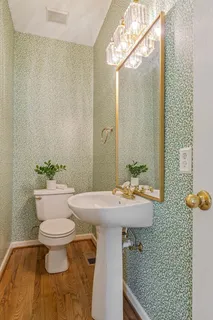 a view of walk in closet with wooden floor and windows