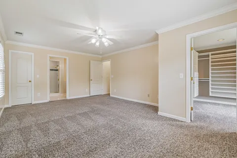 a view of a livingroom with a ceiling fan and window
