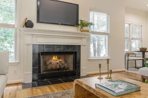 a living room with fireplace and a fireplace