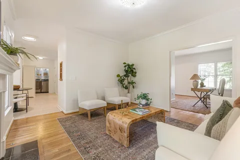 a living room with furniture and a large mirror
