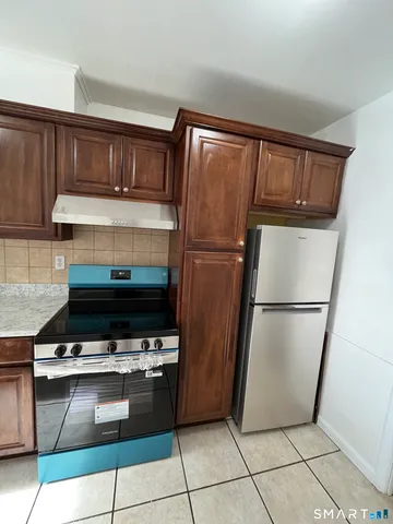 a kitchen with a refrigerator and a stove