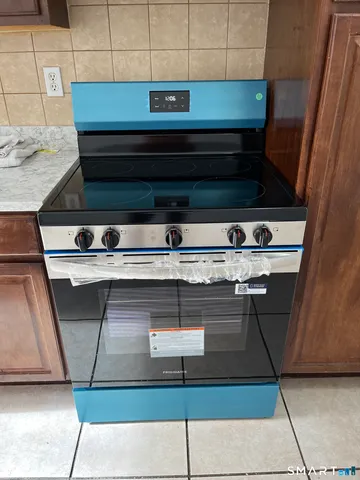 a stove top oven sitting inside of a kitchen