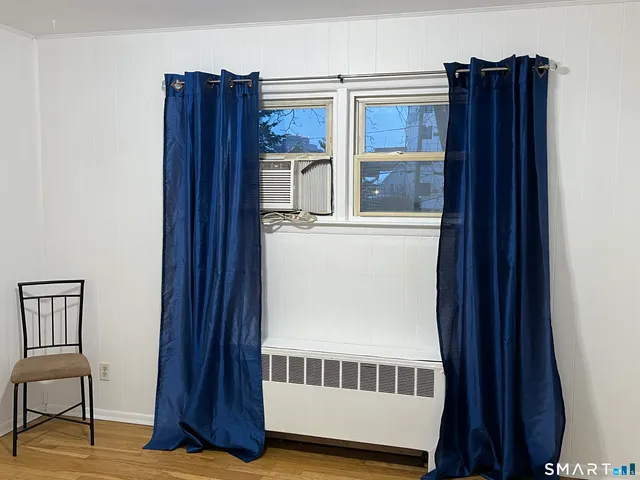 a view of a hallway with wooden floor and entryway