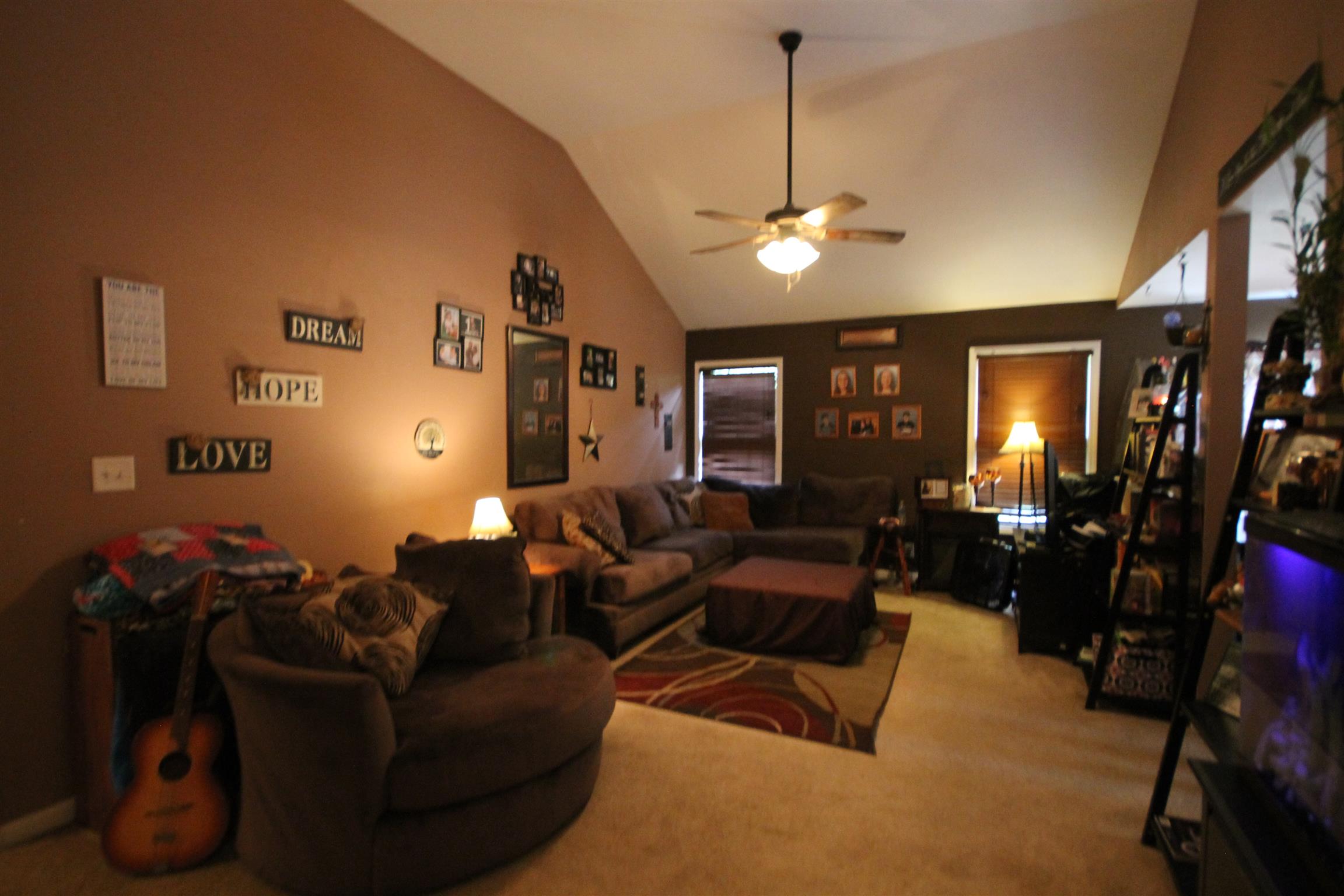 2195 River Road Clarksville, TN 37040 - Photo 7 of 18 a living room with furniture a lamp and a chandelier