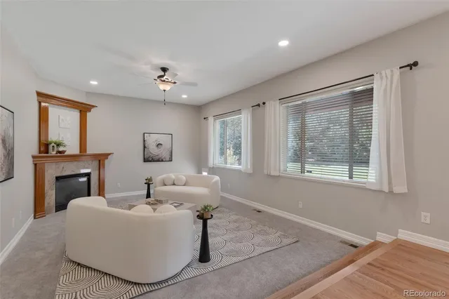 a living room with furniture and a fireplace