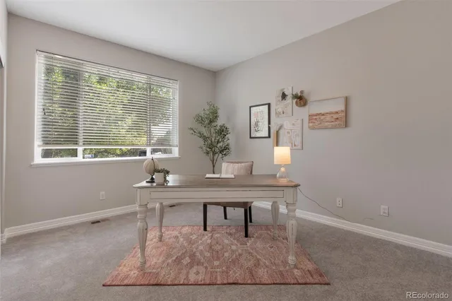 a view of a workspace with furniture