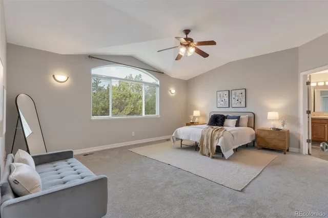 a spacious bedroom with a bed and window