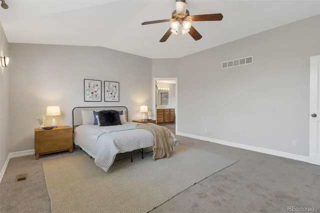 a bedroom with bed and a chandelier