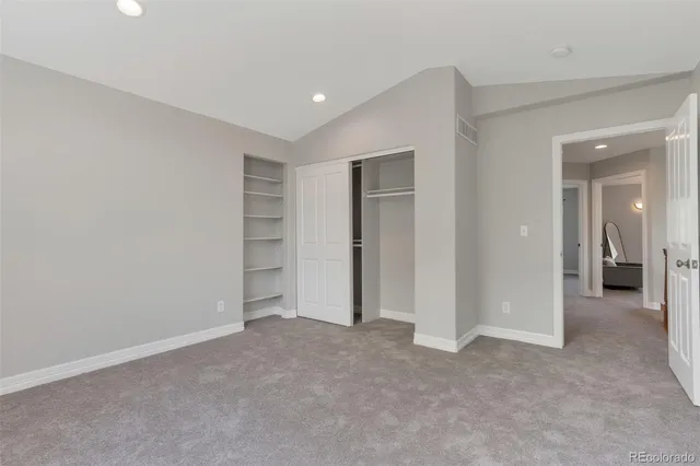 a bathroom with a granite countertop sink a toilet and shower