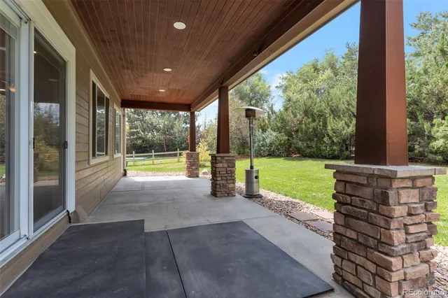 an aerial view of a house with a garden and lake view