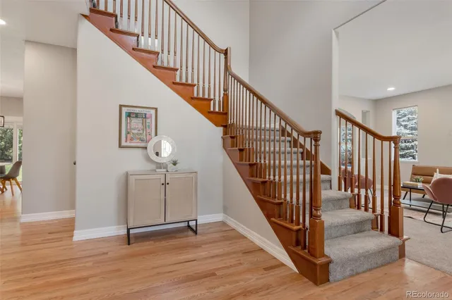 a view of staircase with wooden floor and a rug